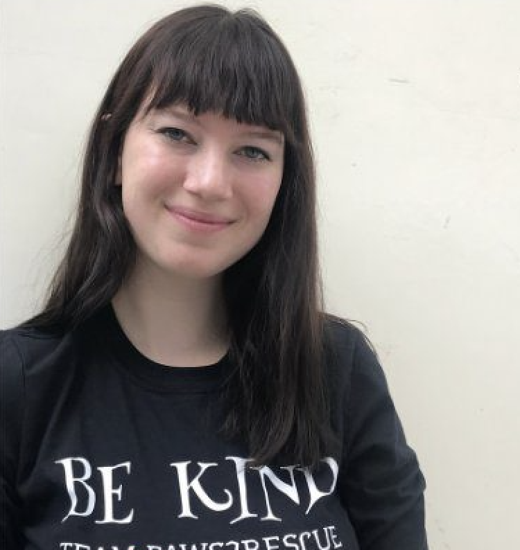 Photo of Paws2Rescue team member Louisa wearing a jumper with the words "Be Kind" printed on the front